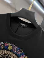 Versace black crewneck T-shirt neckline with brand label and partial rhinestone graphic