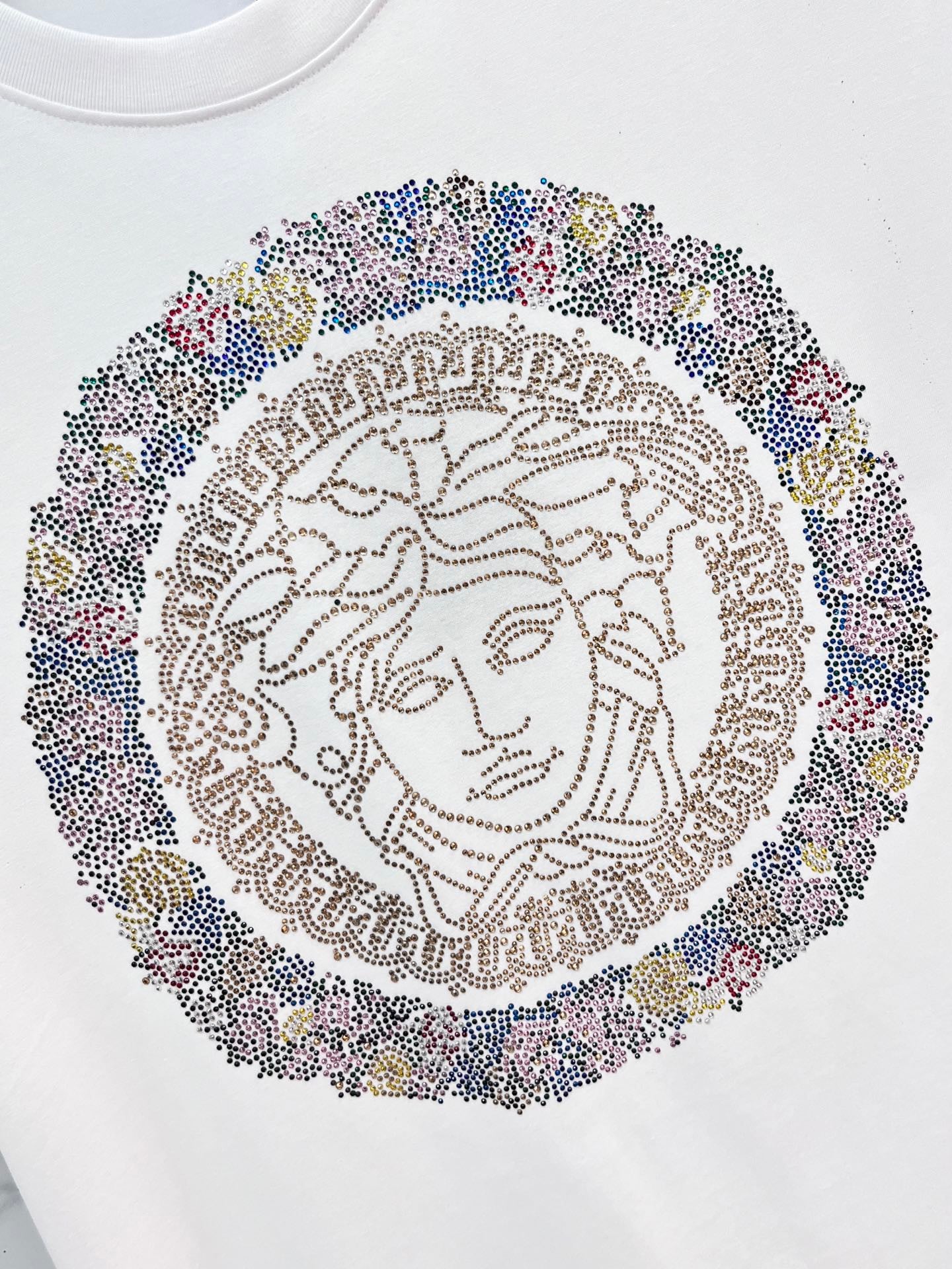 Versace white T-shirt close-up of jeweled Medusa face graphic