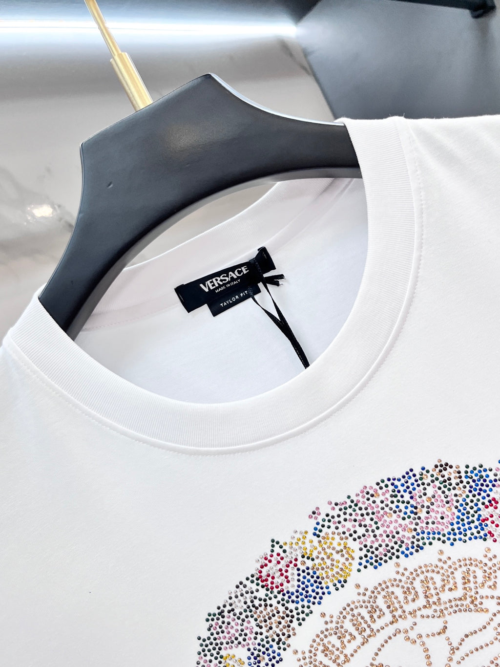 Versace white T-shirt close-up of crew neckline and VERSACE label