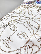 Versace white T-shirt close-up of Medusa rhinestone swirl pattern on chest