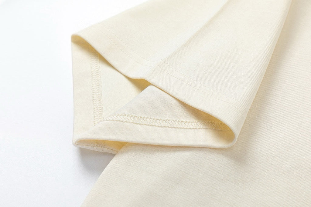 Cream Gucci T-shirt sleeve hem detail with stitched cuff