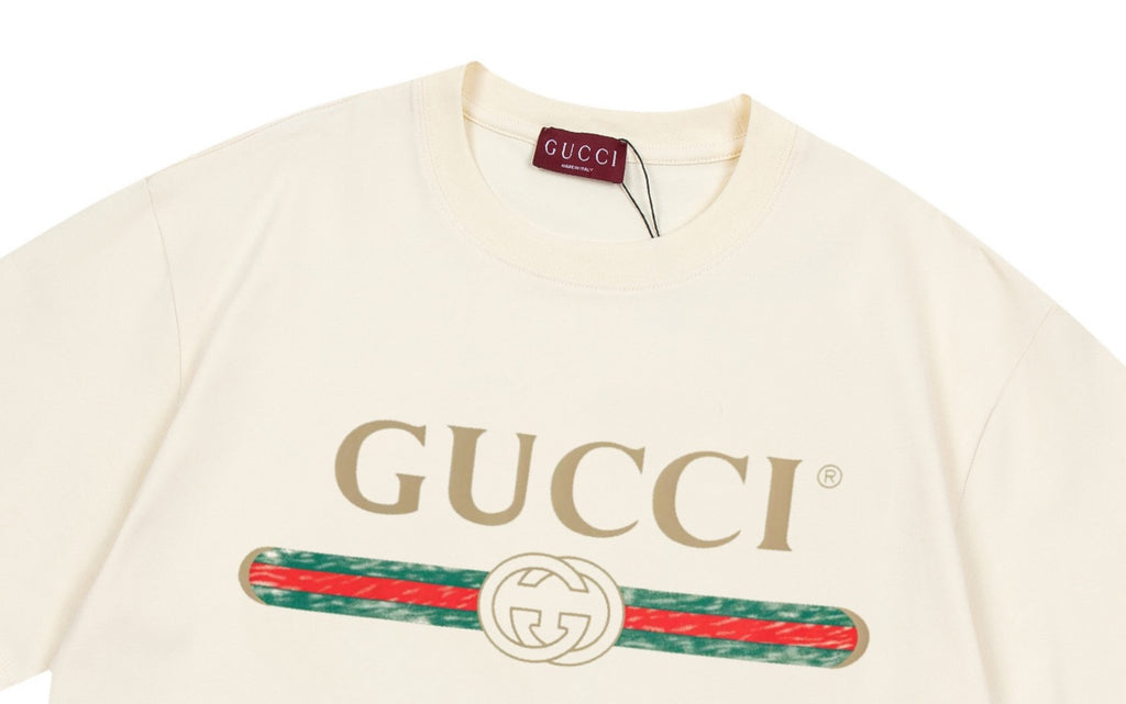 Cream Gucci T-shirt close-up at neckline with large GUCCI logo and emblem