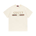 Cream Gucci short-sleeve T-shirt with GUCCI logo and striped emblem graphic