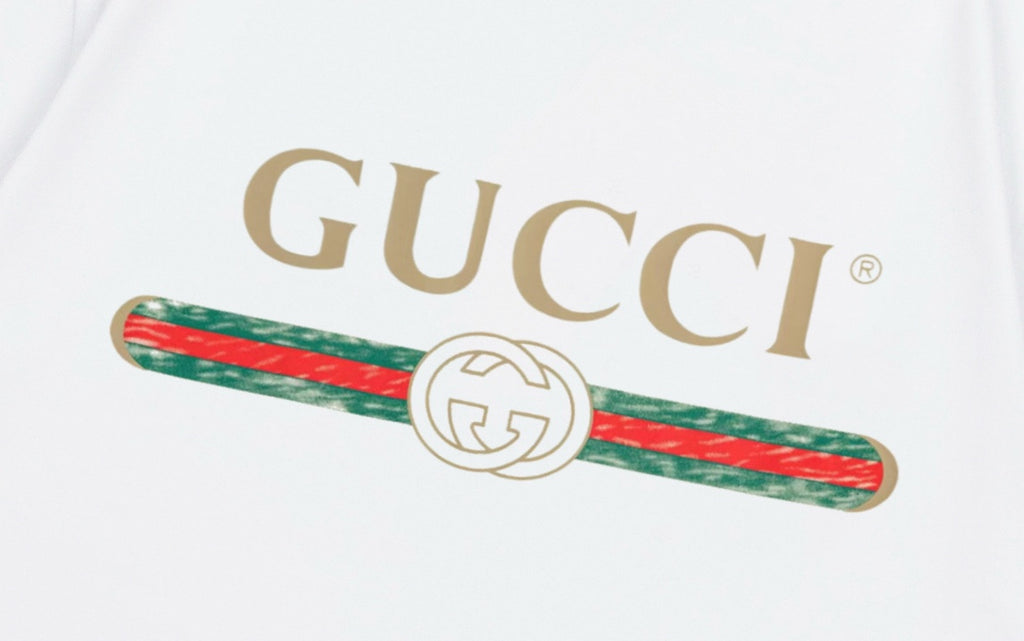 Close-up of GUCCI logo and red-green stripe graphic on white T-shirt
