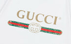 Close-up of GUCCI logo and red-green stripe graphic on white T-shirt