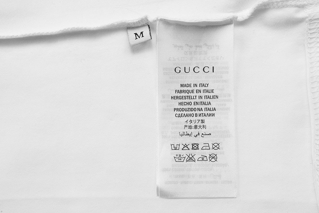 Inside neck label on white Gucci T-shirt with size and care text