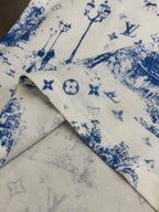 Collar and folded hem detail on off-white T-shirt with blue toile symbol print