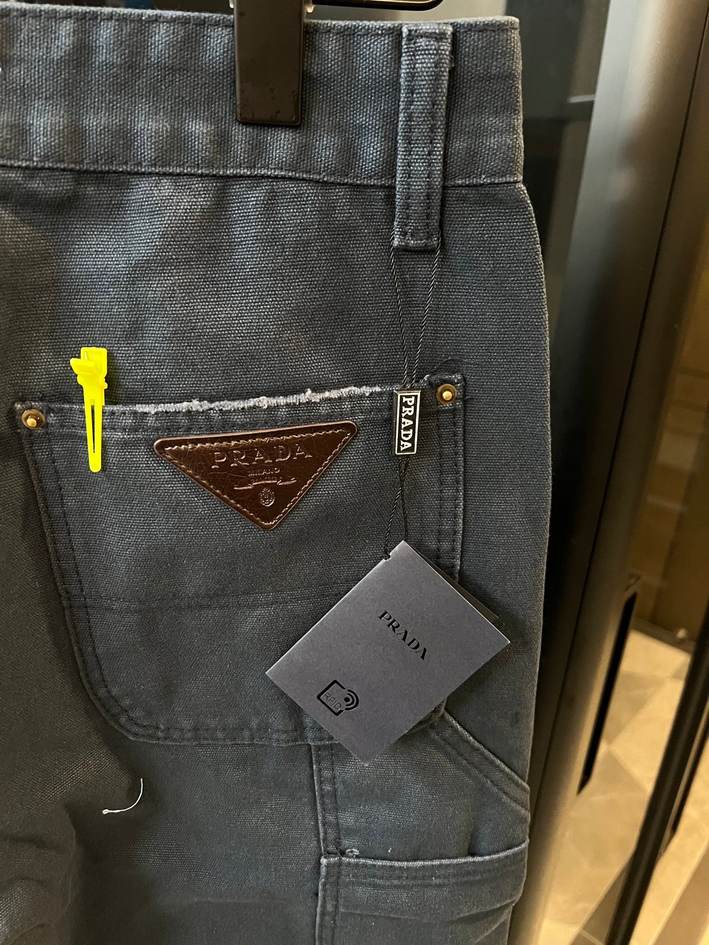 Prada denim cargo pants, dark wash, front logo patch, cargo pocket with button detail
