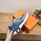 Unisex light-blue high-traction sneakers with white tread sole and lace-up upper