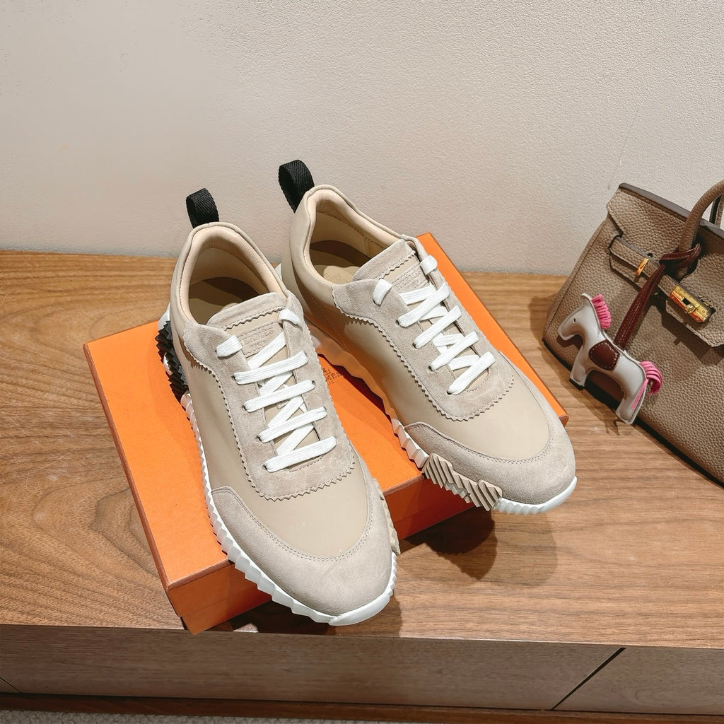 Cream unisex sneakers with white laces, black heel tabs, and ribbed outsole.