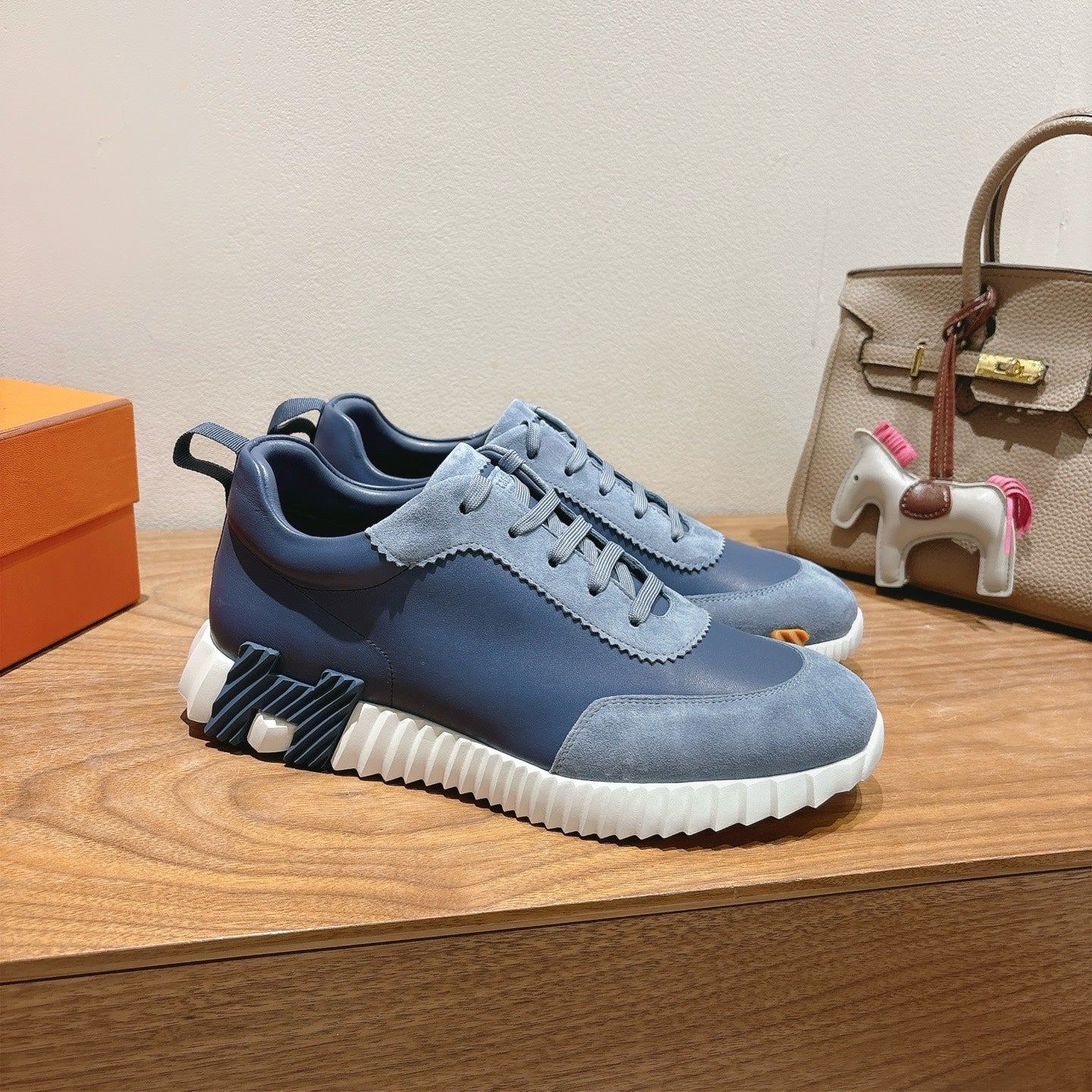 Unisex blue sneakers with lace-up front, textured side panel, and chunky white sole