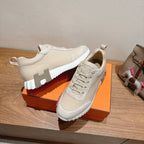 White sneakers with textured laces, padded collar, and ribbed outsole tread