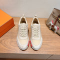 White low-top sneakers with lace-up front and suede toe overlays