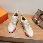 Pair of white lace-up sneakers with pink-and-brown accents at the sides
