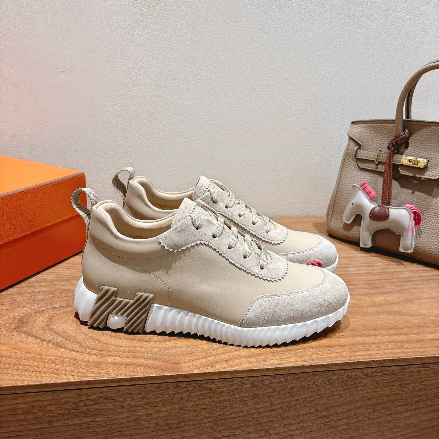 White low-top sneakers with chunky white sole and scalloped side trim