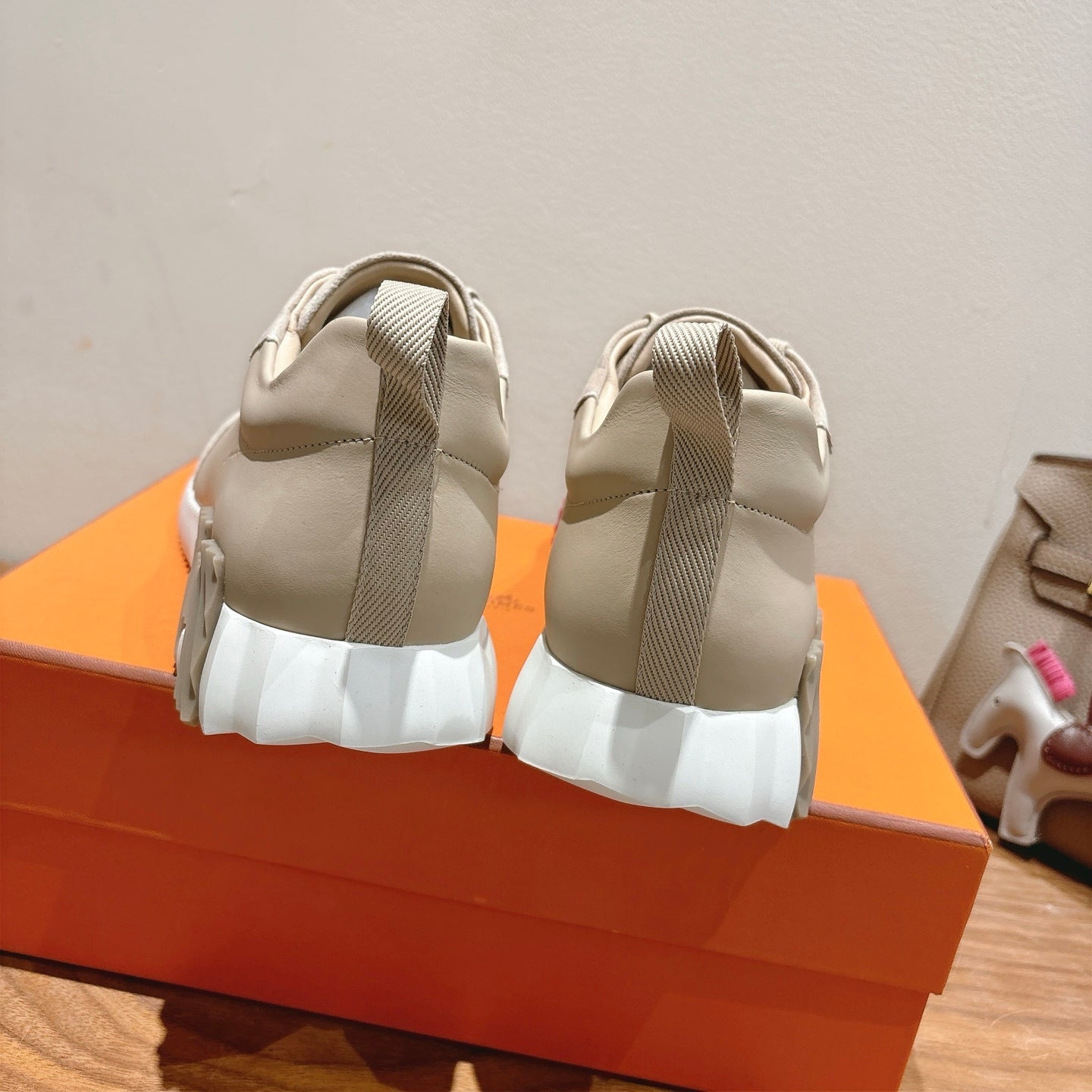 White sneakers with gray elastic heel straps and thick cushioned soles