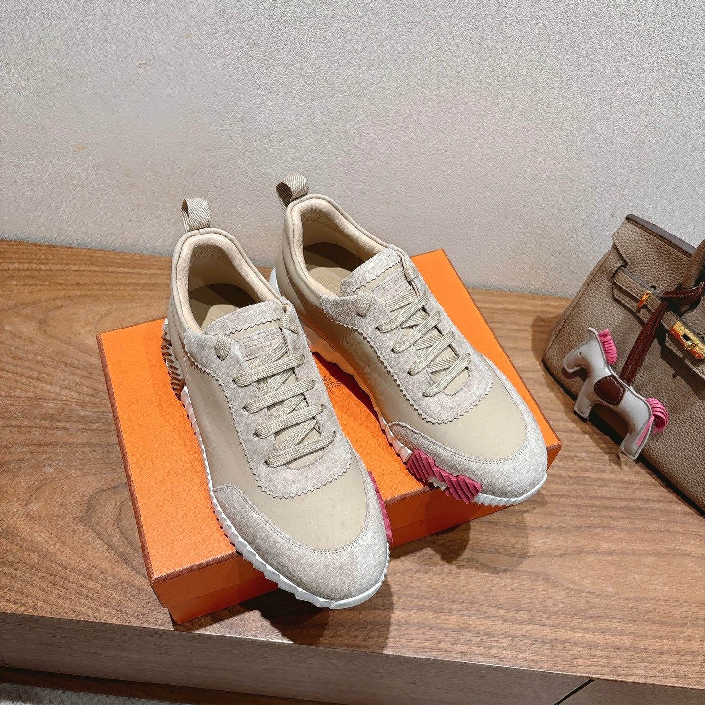 White lace-up sneakers with contrast sock collar and pink trim on heel