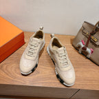 Cream suede lace-up sneakers with white laces and chunky sole, front view pair
