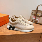 Cream suede lace-up sneakers with black-and-white molded sole, side angle
