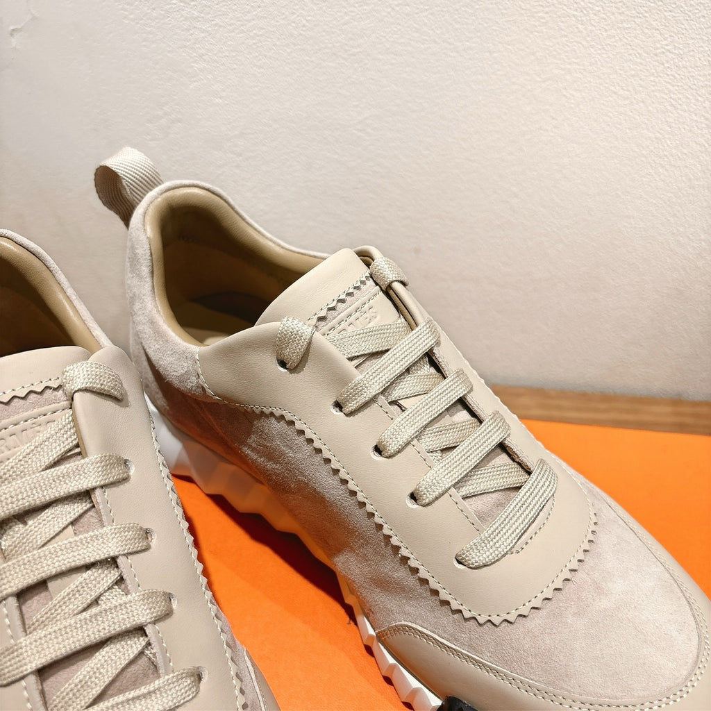 Cream suede sneaker upper with lace-up front and stitched trim, close-up
