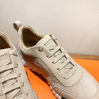 Cream suede sneaker upper with lace-up front and stitched trim, close-up
