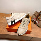 Cream suede lace-up sneakers with black logo panel on white-and-black platform sole