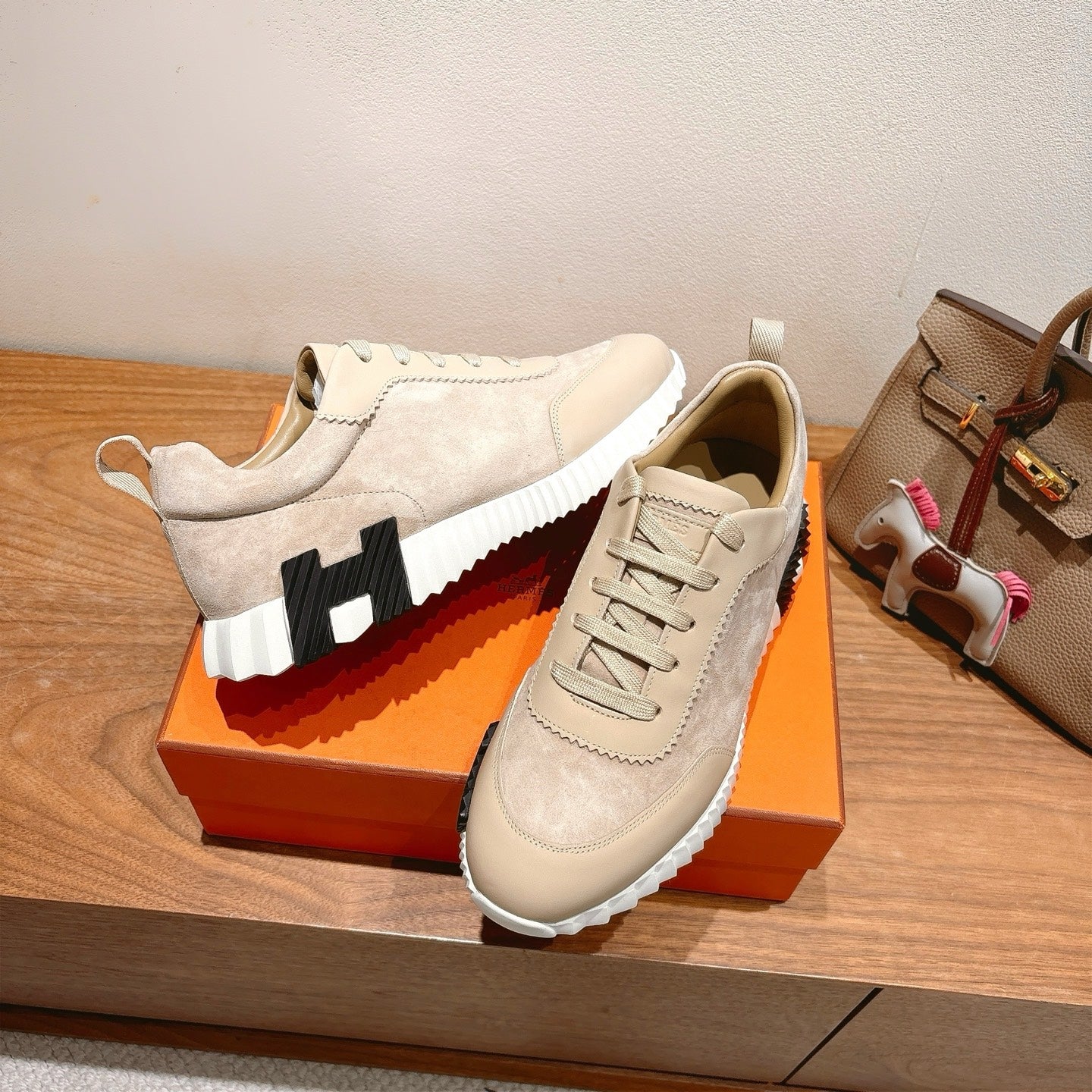 Cream suede lace-up sneakers with black logo panel on white-and-black platform sole