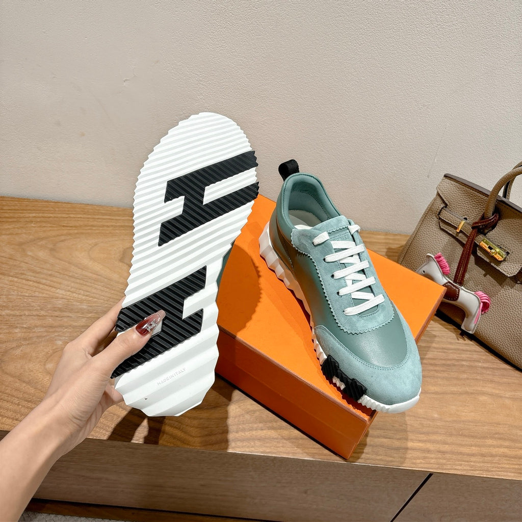 Hermes mint unisex sneaker showing treaded white outsole with black traction blocks.