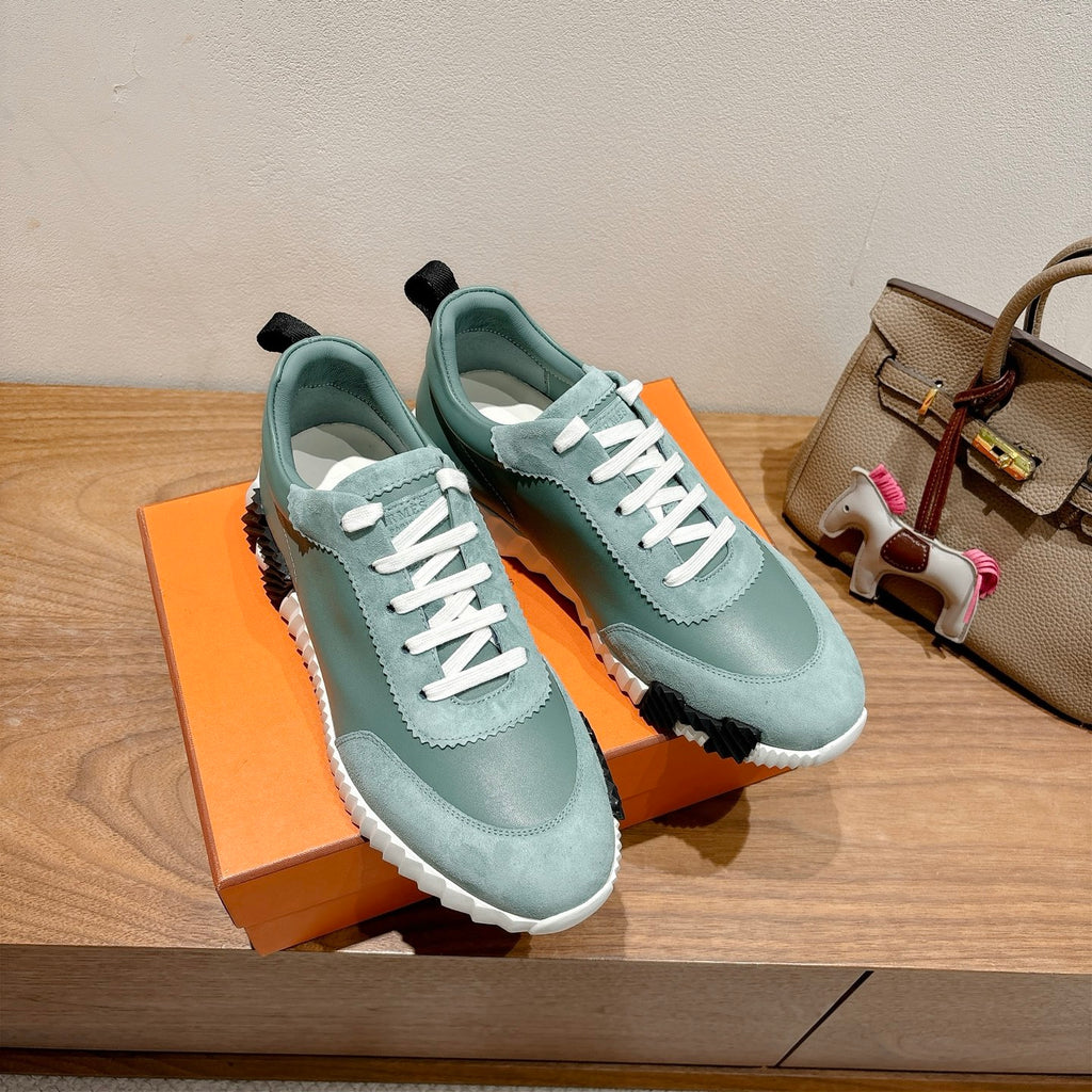 Hermes mint unisex lace-up sneakers with white laces, black heel tabs, thick sole.