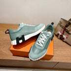Hermes mint unisex sneakers with white laces and chunky striped sole, side logo detail.