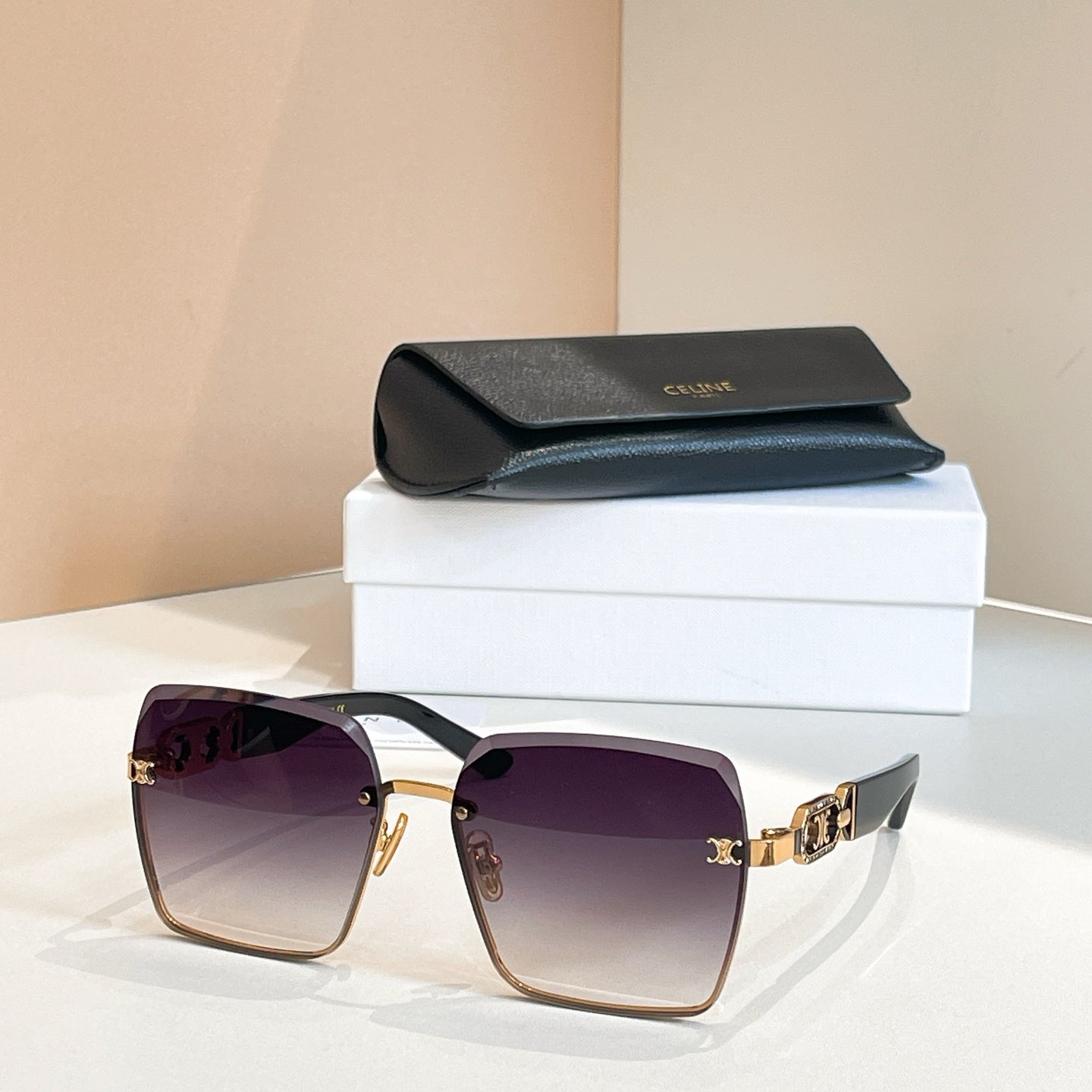 Celine sunglasses with dark frames and purple lenses, gold chain-link temple detail