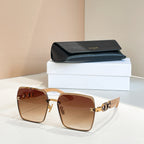 Celine sunglasses with tan frames and amber lenses, gold link-style temple detail