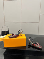 Women's Louis Vuitton monogram slingback heels with red bow, heel-toe angle on box