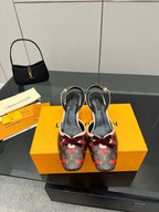 Women's Louis Vuitton monogram slingback heels with red bow and slim heel, pair view