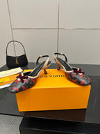 Pair of women’s slingback flats with cherry print, burgundy bows, black straps, kitten heels