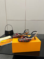 Women's Louis Vuitton monogram slingback heels with red bow, side view on box