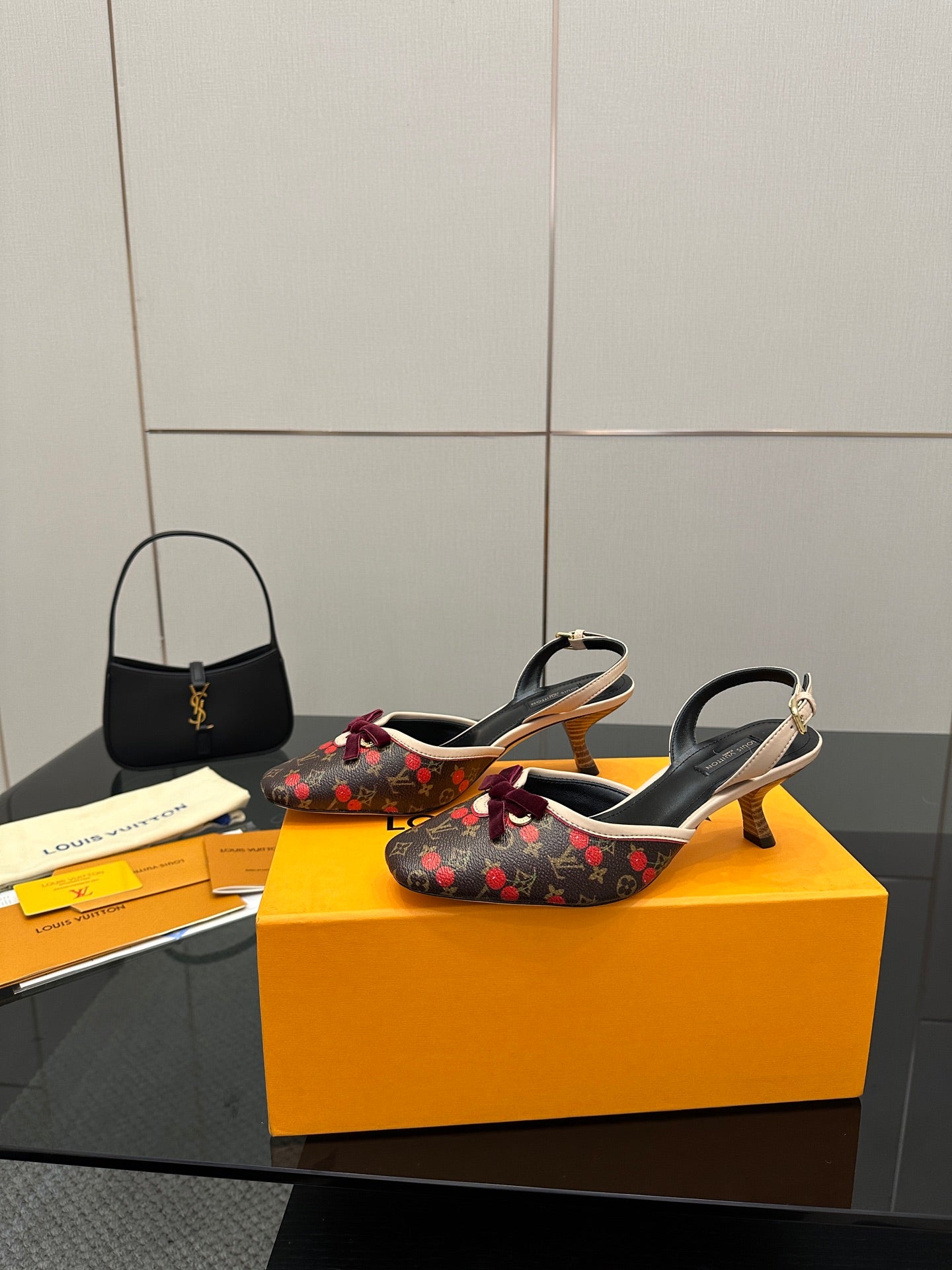 Women's Louis Vuitton monogram slingback heels with red bow, side view on box