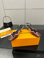 Women's Louis Vuitton monogram slingback heels with red bow, two shoes side-by-side