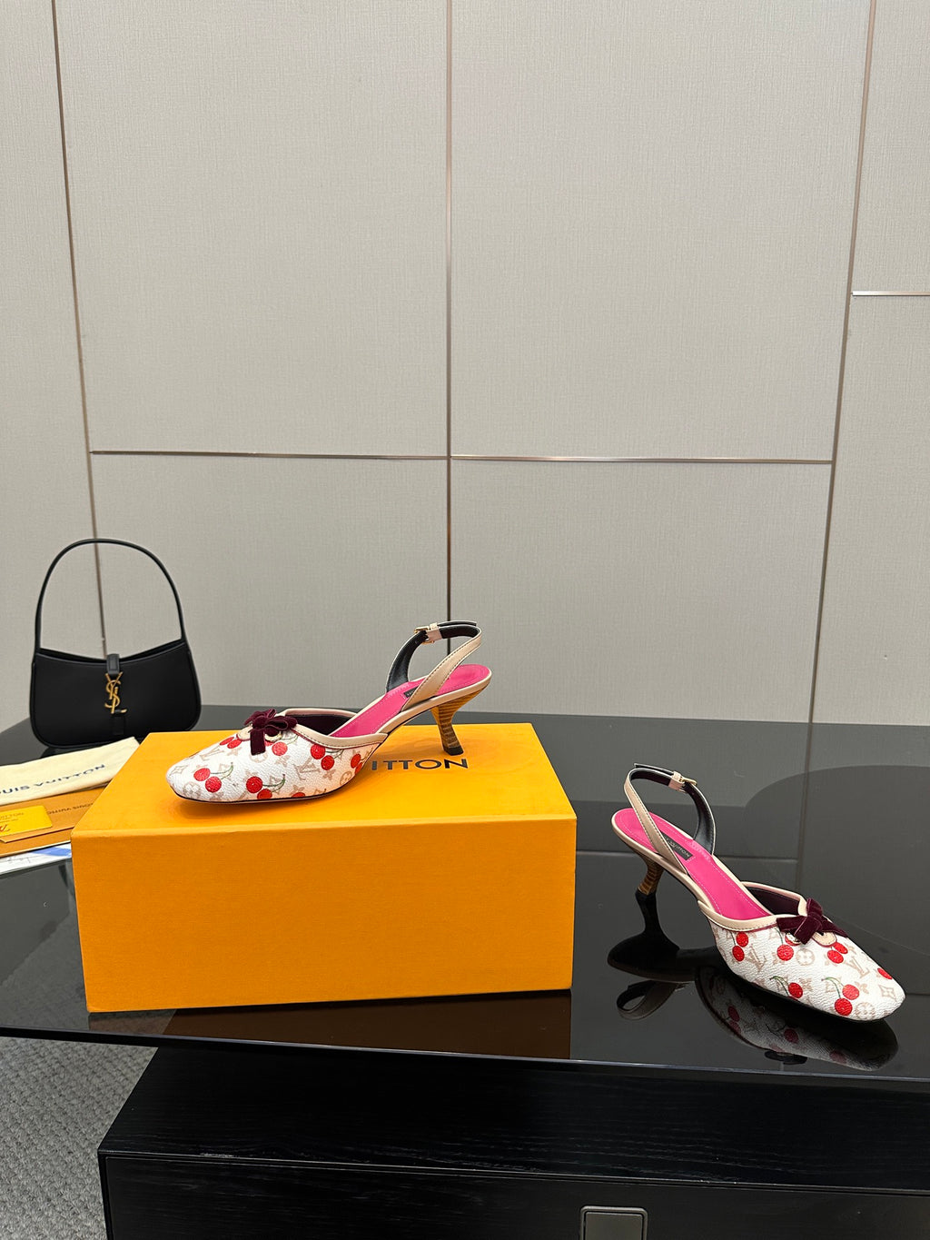Heeled slingback shoes, white with red cherries, fuchsia interior, and bow at toe.