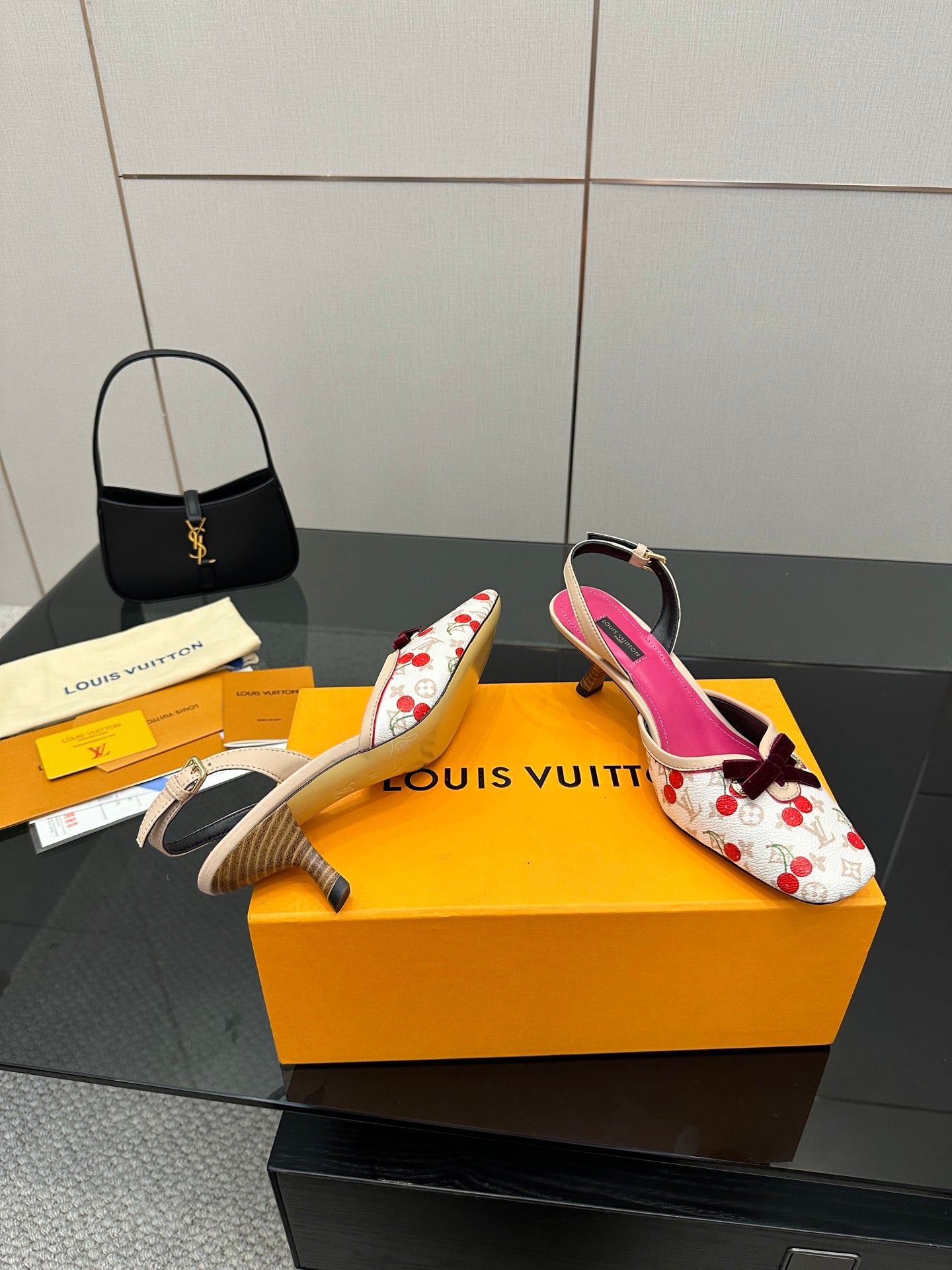 Slingback heeled shoes, white with red cherry print, fuchsia lining, and curved heel.