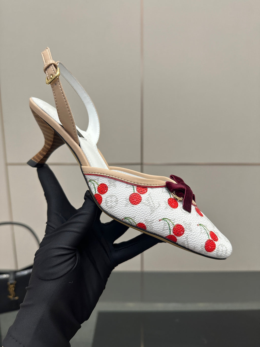 Women's cherry-print slingback heel showing bow accent and beige heel sole