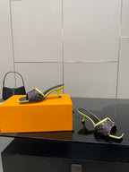 Louis Vuitton slide sandal pair with multicolor monogram print and neon green straps