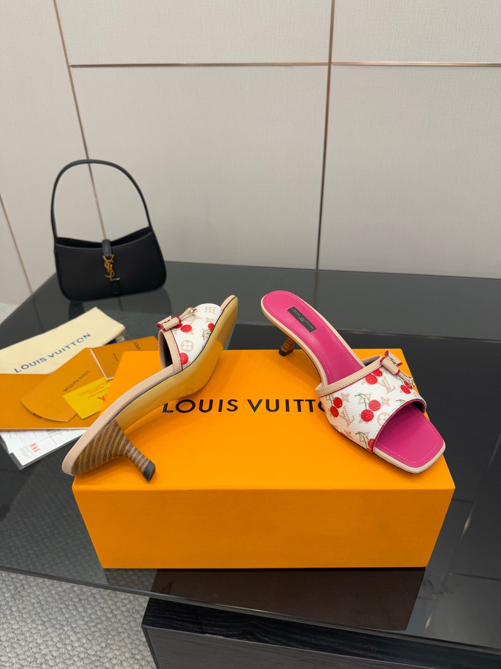 Pink and white cherry print heeled slide mules, angled view