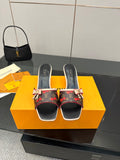 Louis Vuitton slide mules with black leather trim and floral monogram fabric, bow detail