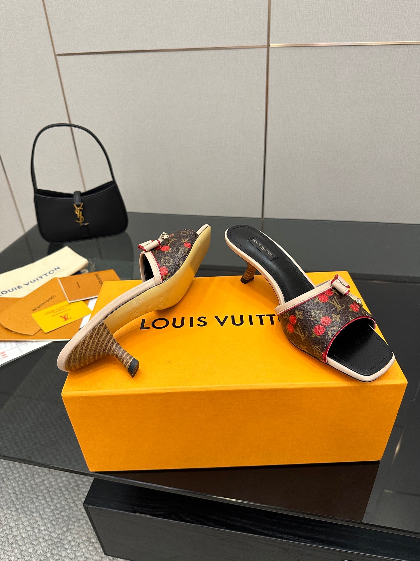 Louis Vuitton slide mule with floral monogram upper, cream edging, and high heel