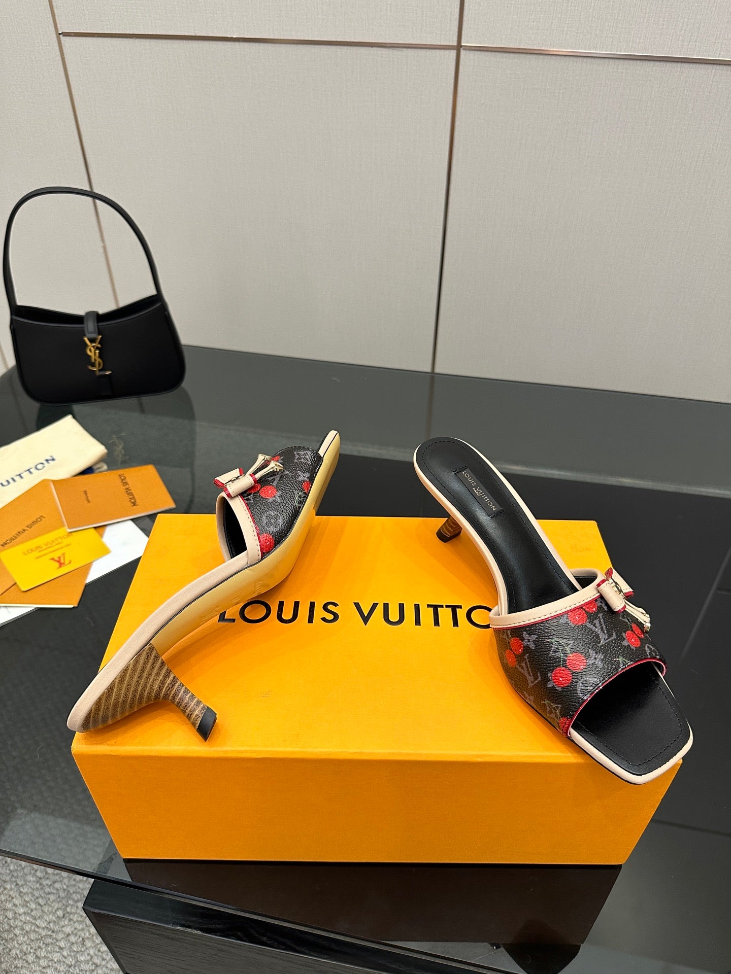 Louis Vuitton ladies slide mules, black with red cherry pattern, beige sole detail