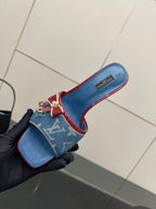 Louis Vuitton women's blue monogram slide mule with red border and bow detail