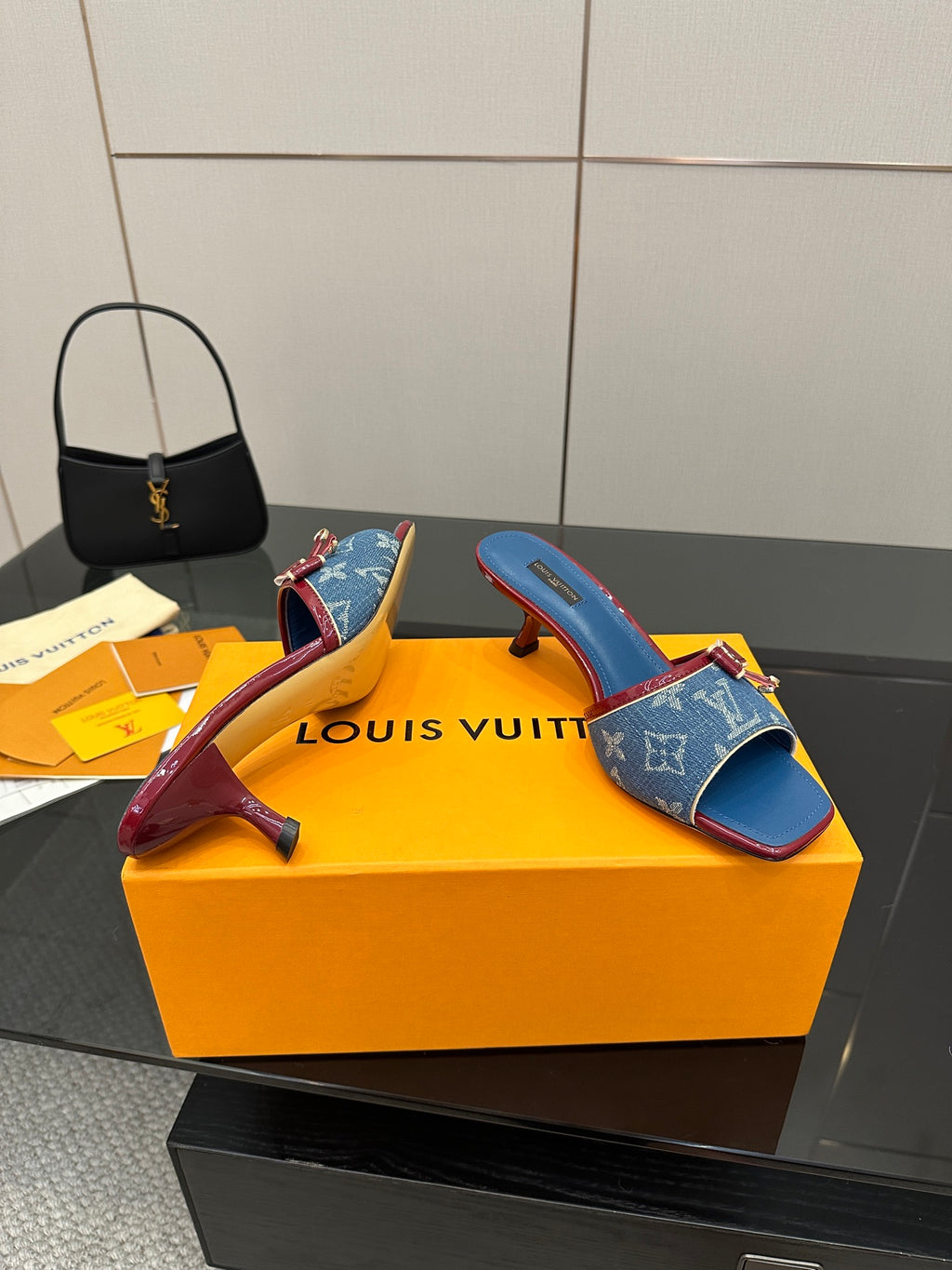 Louis Vuitton women's blue monogram slide mules with red sole edge and bow