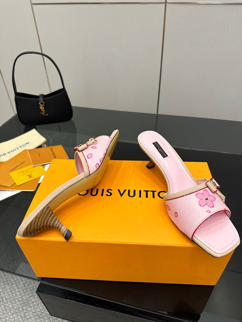 Pink slide sandals with flower appliqué strap and small buckle on block heel