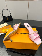 Pink slide sandals with flower appliqué strap and small buckle on block heel